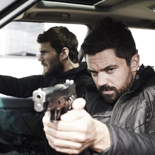 Austin Stowell stars as Hank and Dominic Cooper stars as John Stratton in Momentum Pictures' Stratton (2018)