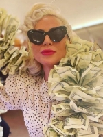 Lady Gaga Returns to Las Vegas in Polka Dot Dress & Boa Made of Money