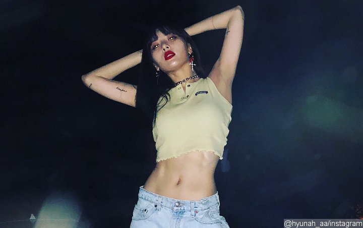 Hyuna trending with a picture wearing a bra over T-shirt