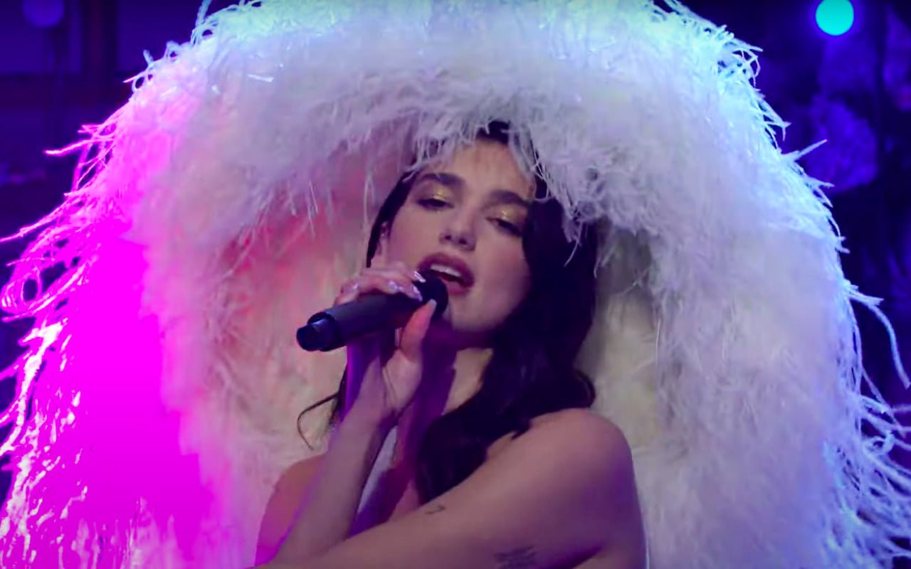 Dua Lipa Draws In Hilarious Comparisons for Feathered Hat Worn During 'SNL' Performance
