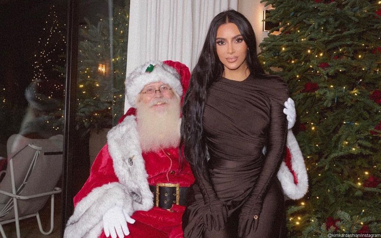 Kim Kardashian Sits on Santa's Lap at Kardashian Christmas Eve Party