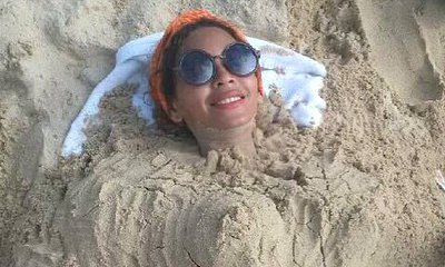 Beyonce Knowles Seems to Confirm Pregnancy With Sand Baby Bump Picture