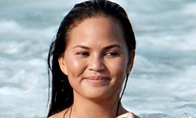 Chrissy Teigen Is Fully Naked While Playing in the Ocean for Photo Shoot