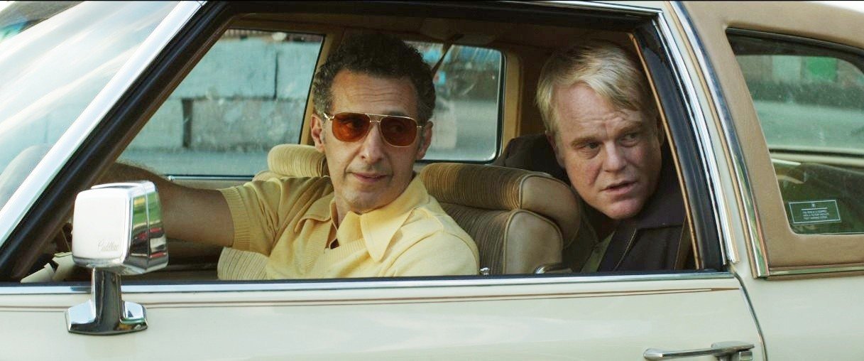 John Turturro and Philip Seymour Hoffman (Mickey Scarpato) in IFC Films' God's Pocket (2014)