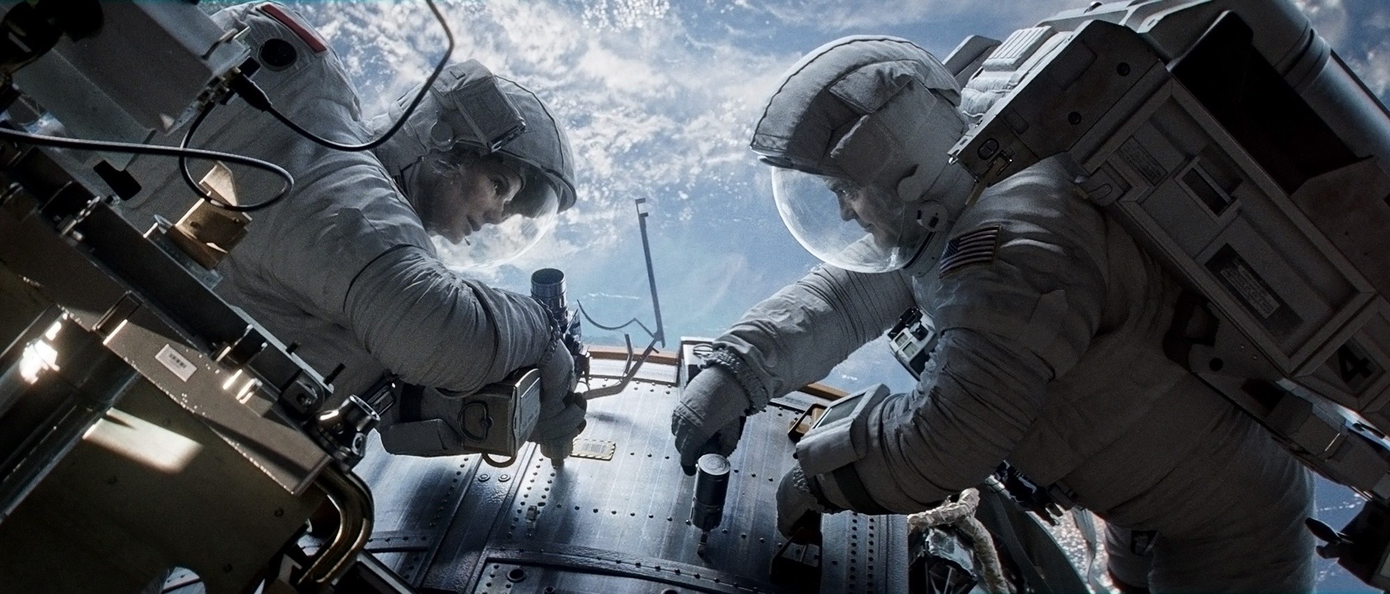 Sandra Bullock stars as Dr. Ryan Stone and George Clooney stars as Matt Kowalsky in Warner Bros. Pictures' Gravity (2013)