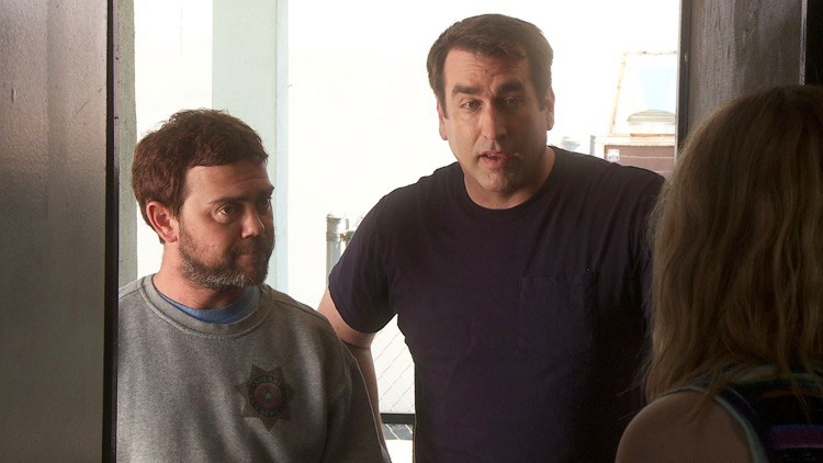 Rob Riggle stars as James Malone Sr. and Joe Lo Truglio stars as Officer Fogerty in Millennium Entertainment's High Road (2012)