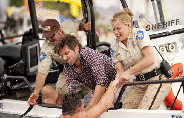Adam Scott stars as Novak Radzinsky and Elisabeth Shue stars as Sheriff Julie Forester in Dimension Films' Piranha 3-D (2010)