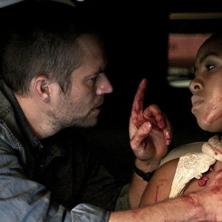 Paul Walker stars as Michael Woods and Naima McLean stars as Rachel Shabangu in Ketchup Entertainment's Vehicle 19 (2013)